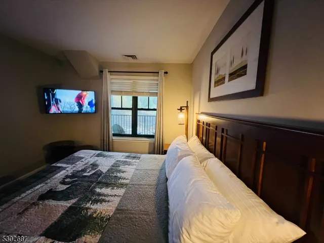 a bedroom with furniture and a window