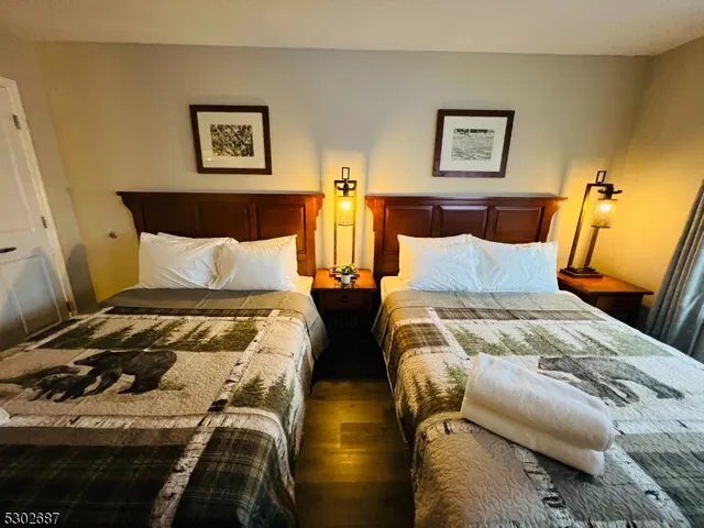 a bedroom with a bed and painting on the wall