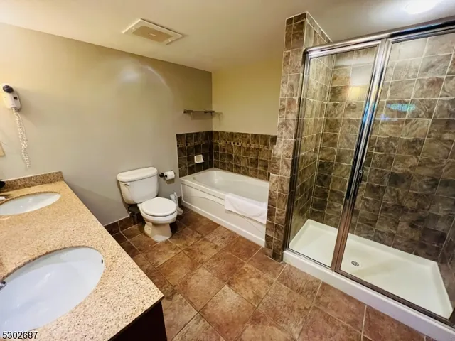 a bathroom with a sink toilet and mirror
