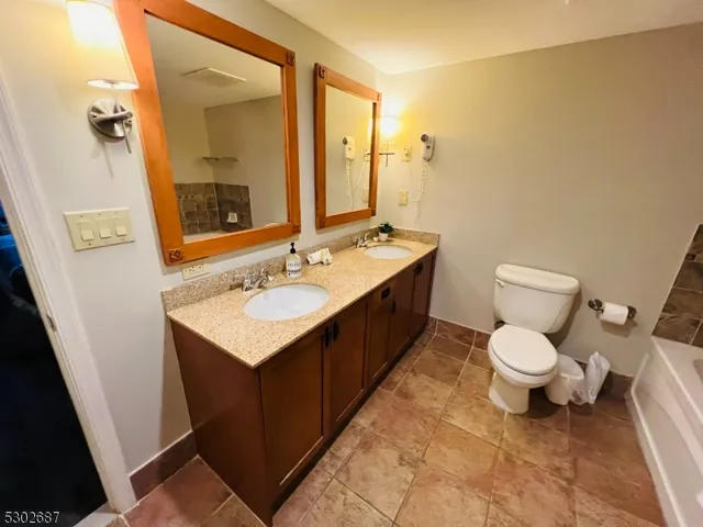 an aerial view of residential house with outdoor space and trees all around