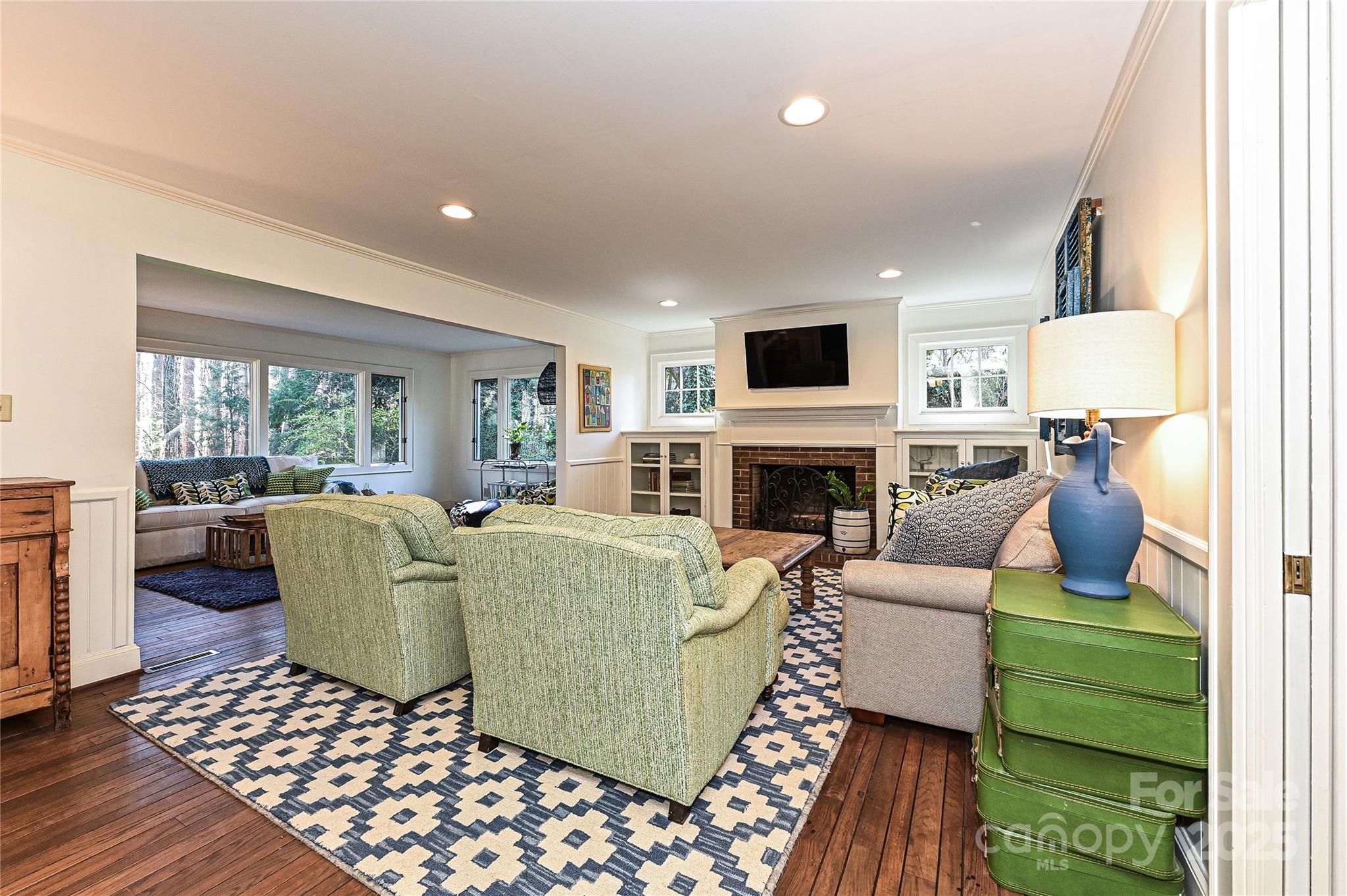 525 Pine Road Davidson, NC 28036 - Photo 7 of 33 a living room with furniture a large window and a fireplace