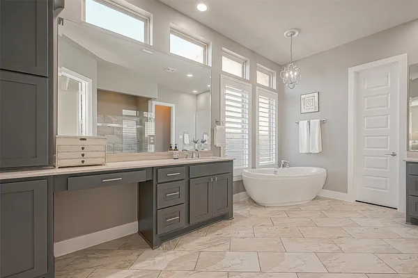 a bathroom with a double vanity sink a toilet and shower