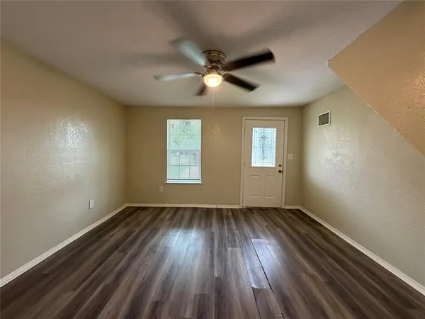 wooden floor in an empty room with a window