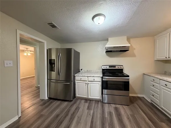 a kitchen with stainless steel appliances a stove a refrigerator and a sink