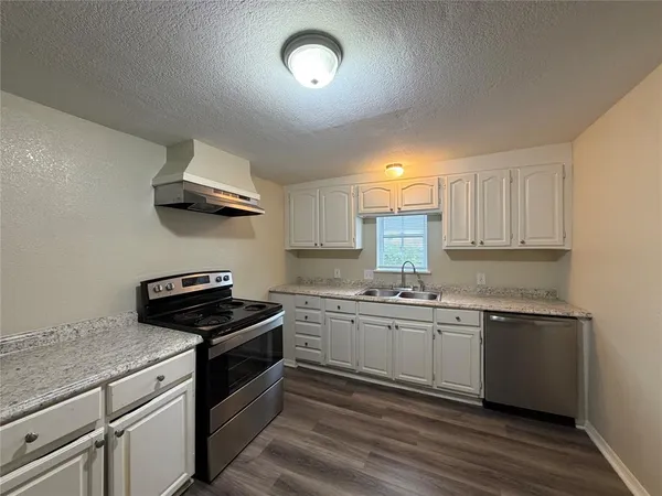 a kitchen with stainless steel appliances granite countertop a sink a stove a microwave and island