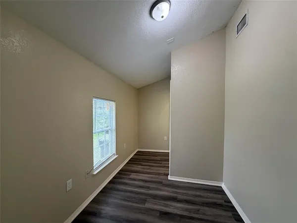 a view of wooden floor and windows in a room