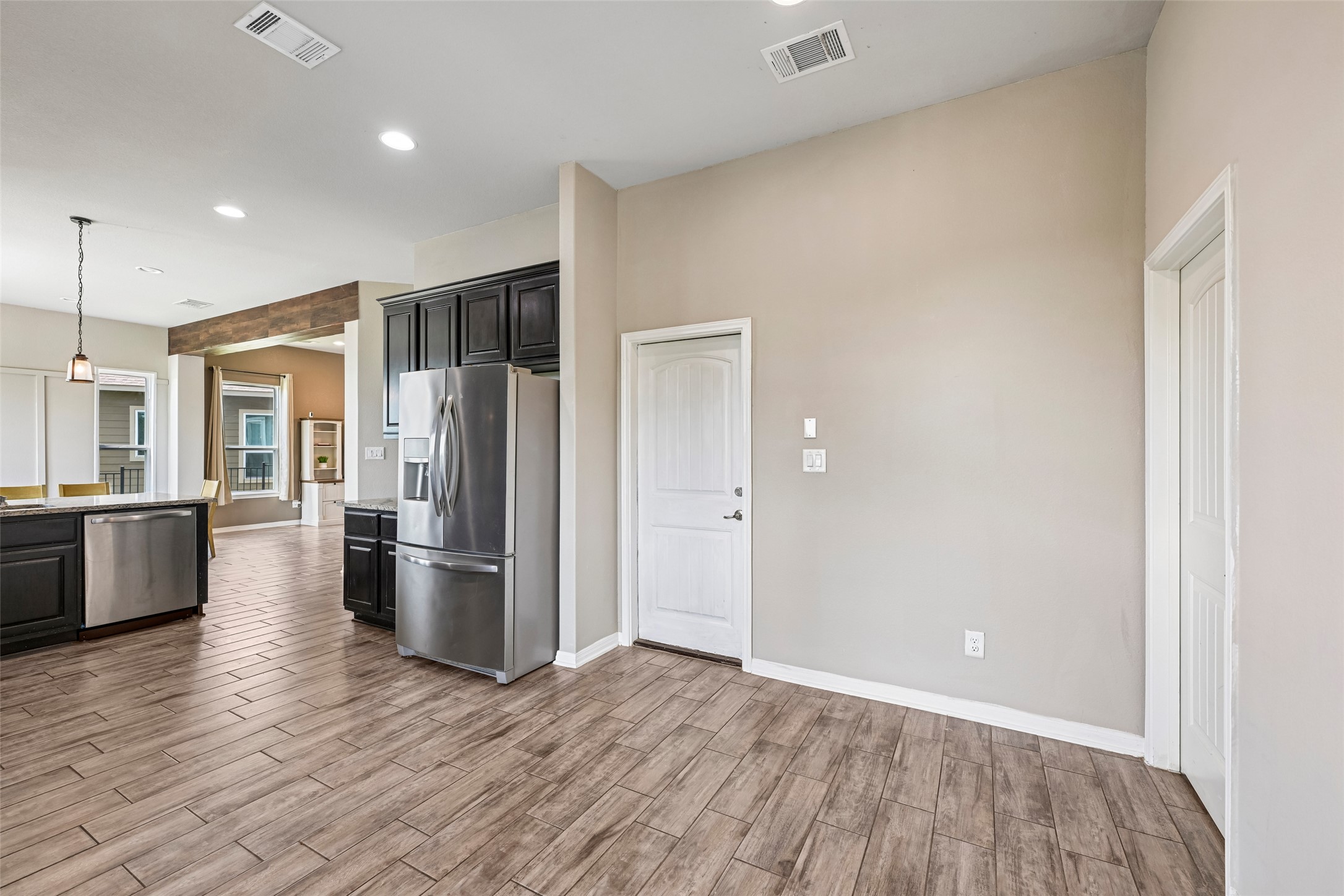 1297 Harwell Loop Kyle, TX 78640 - Photo 16 of 39 Stainless steel appliances and rich cabinetry define this inviting kitchen space.