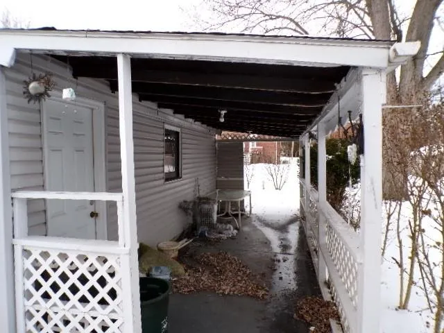 a view of empty room with window and ceiling fan