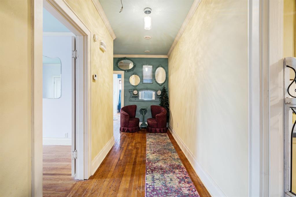 824 South Main Street Paris, TX 75460 - Photo 11 of 18 a view of a hallway with wooden floor and a living room