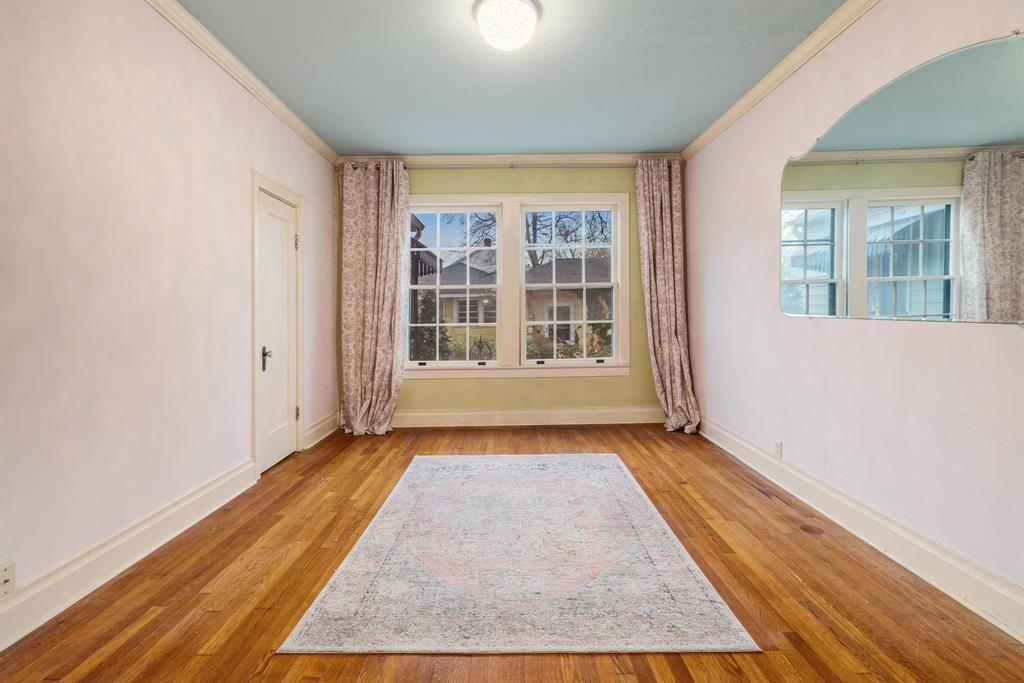 824 South Main Street Paris, TX 75460 - Photo 12 of 18 an empty room with wooden floor and windows