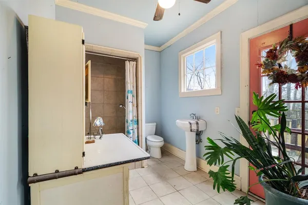 a bathroom with a sink a toilet and mirror