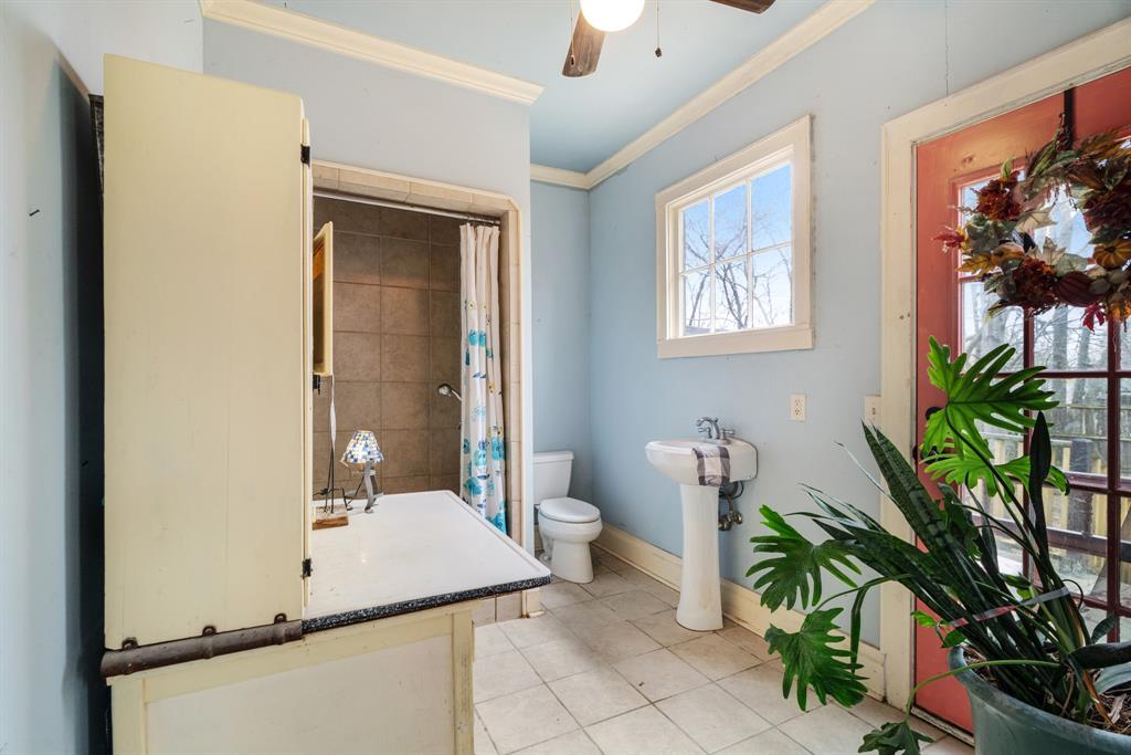 824 South Main Street Paris, TX 75460 - Photo 15 of 18 a bathroom with a sink a toilet and mirror