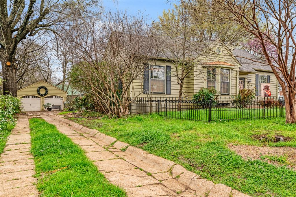 824 South Main Street Paris, TX 75460 - Photo 17 of 18 a view of a yard in front of a brick house with many windows