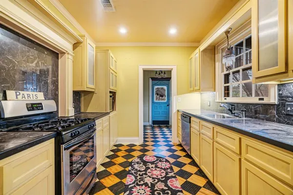 a kitchen with stainless steel appliances granite countertop a stove and a sink