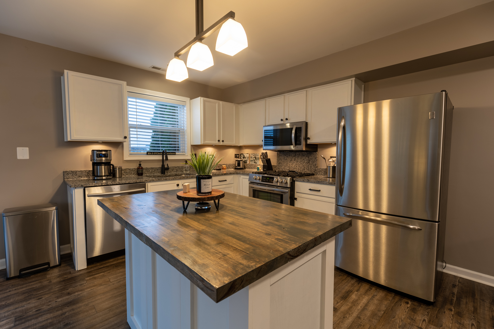 25101 Faraday Road Manhattan, IL 60442 - Photo 2 of 26 a kitchen with kitchen island granite countertop stainless steel appliances a refrigerator microwave and sink