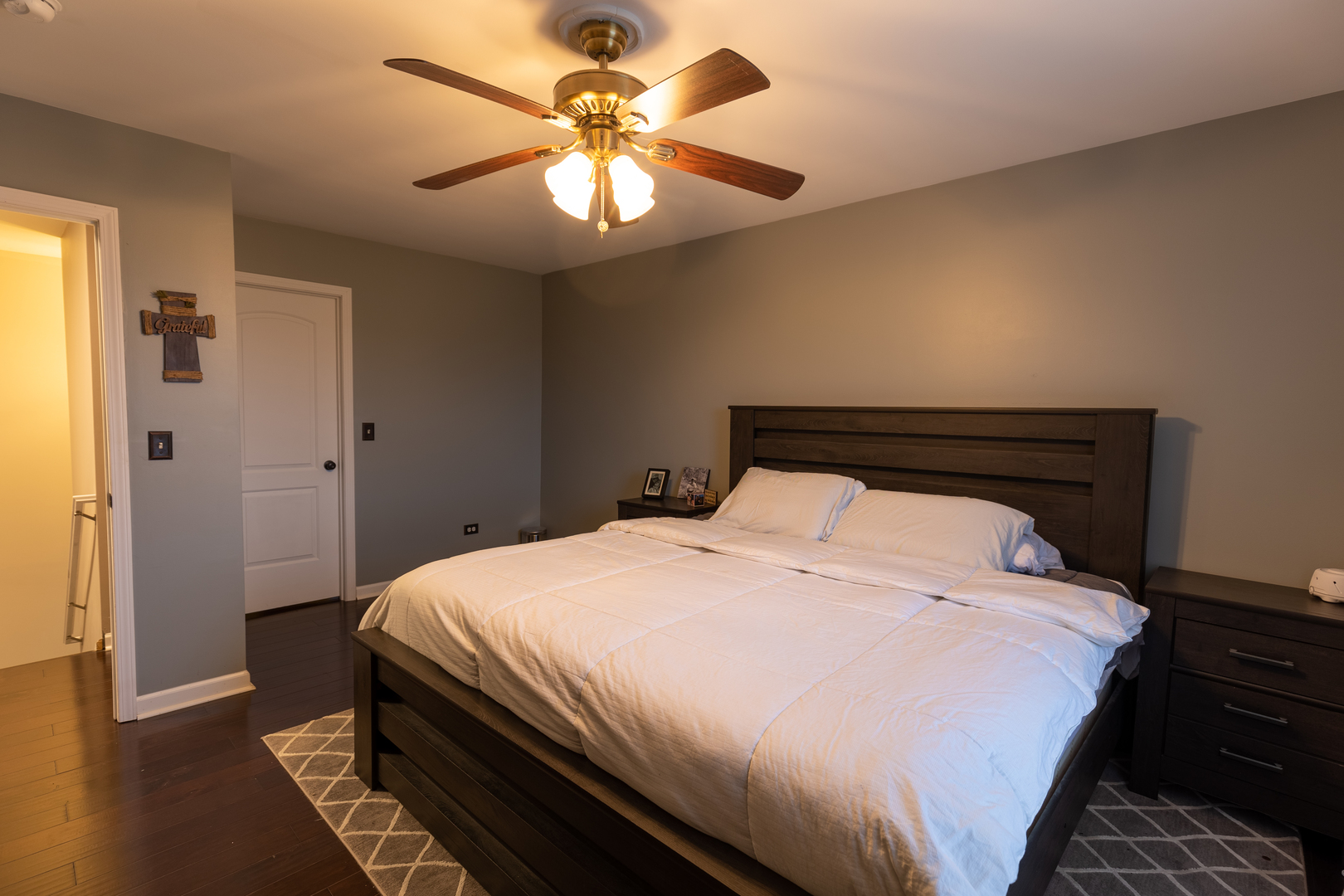 25101 Faraday Road Manhattan, IL 60442 - Photo 12 of 26 a bedroom with a bed and a chandelier