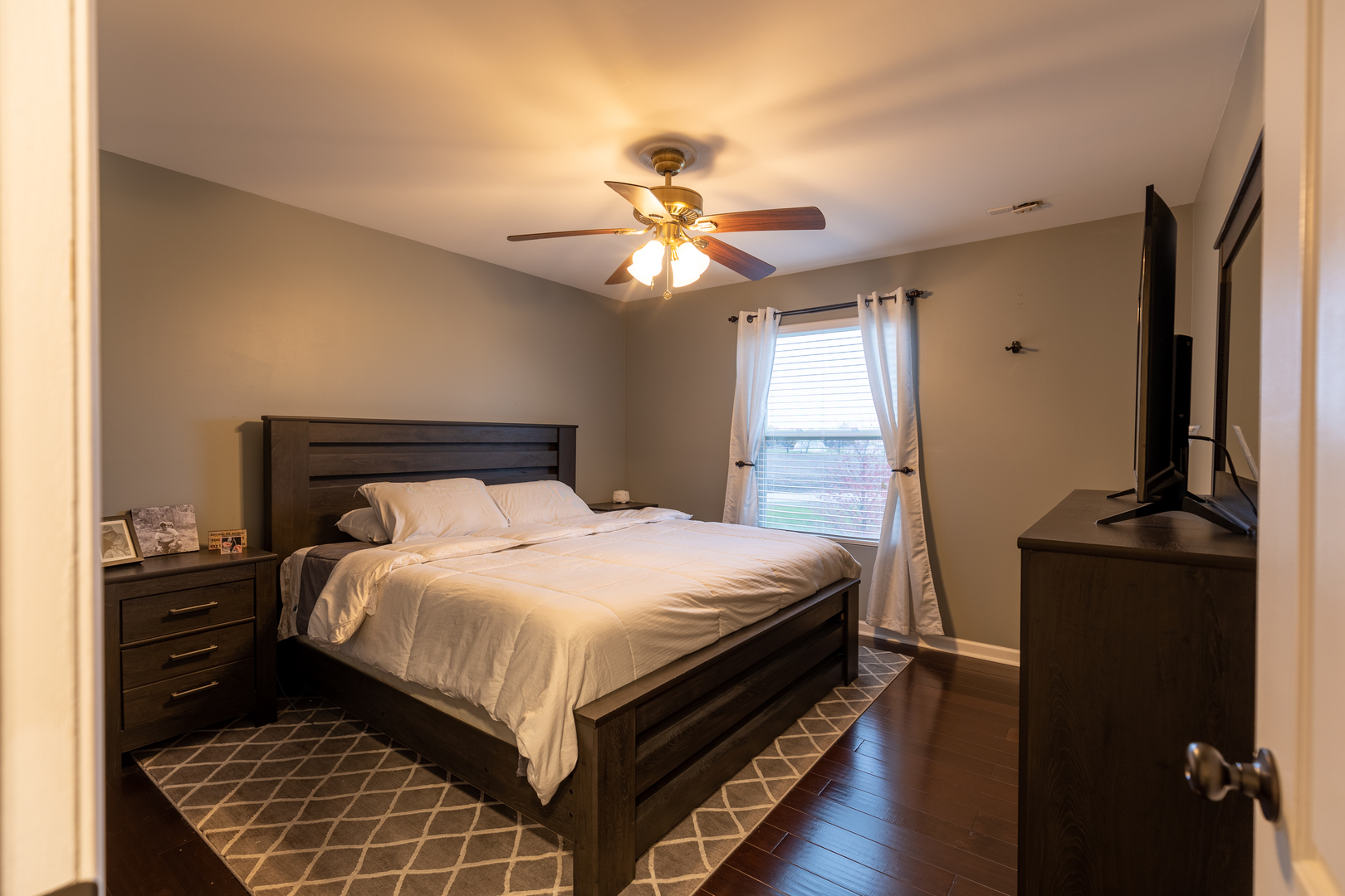 25101 Faraday Road Manhattan, IL 60442 - Photo 13 of 26 a bedroom with a bed and a chandelier