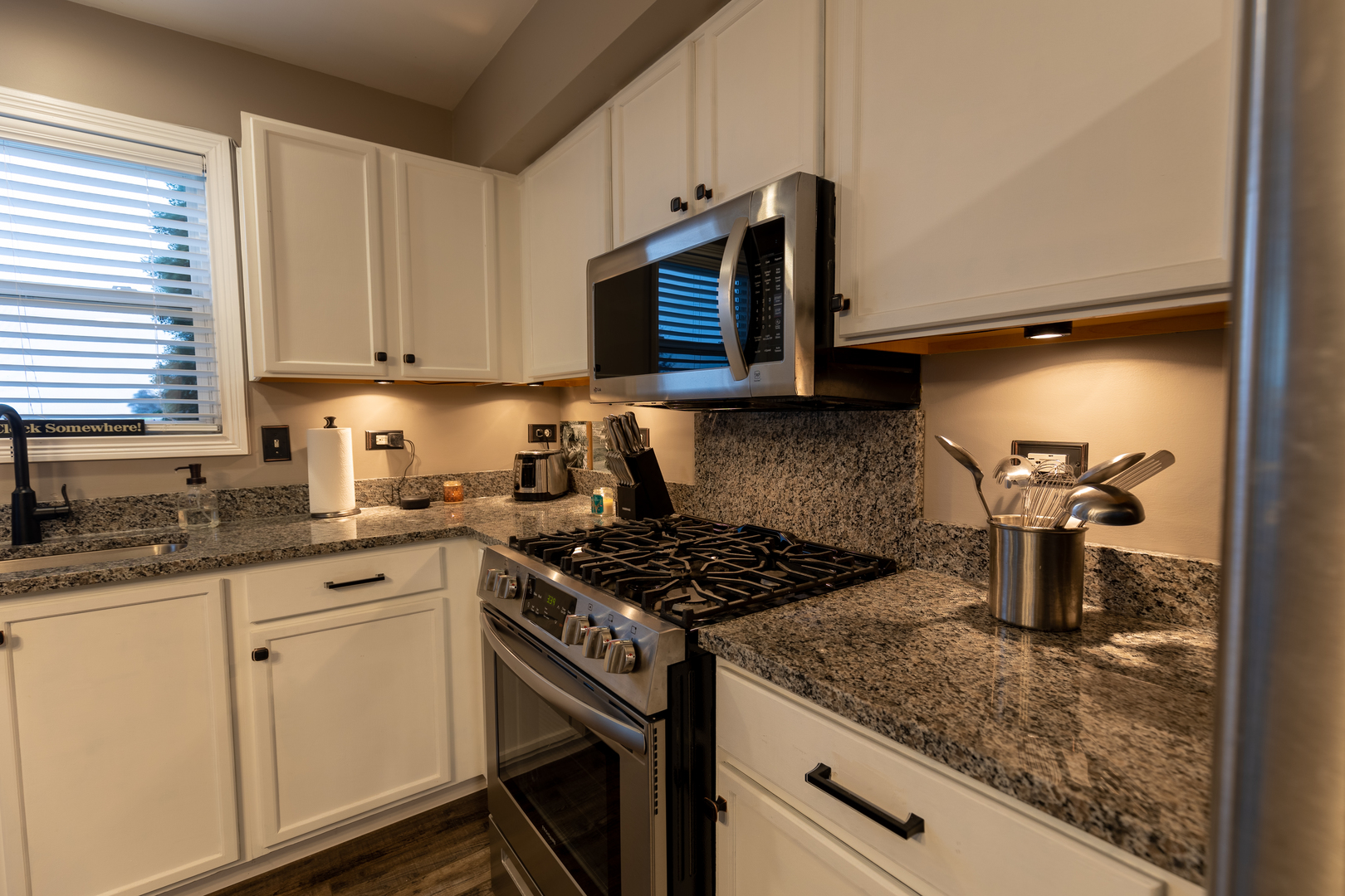 25101 Faraday Road Manhattan, IL 60442 - Photo 3 of 26 a kitchen with granite countertop a sink stove and cabinets