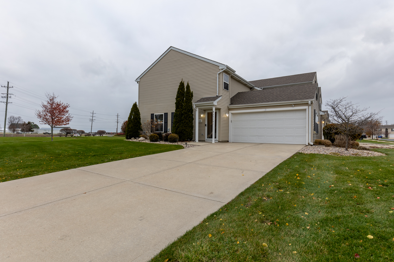 25101 Faraday Road Manhattan, IL 60442 - Photo 23 of 26 a front view of a house with a yard and garage