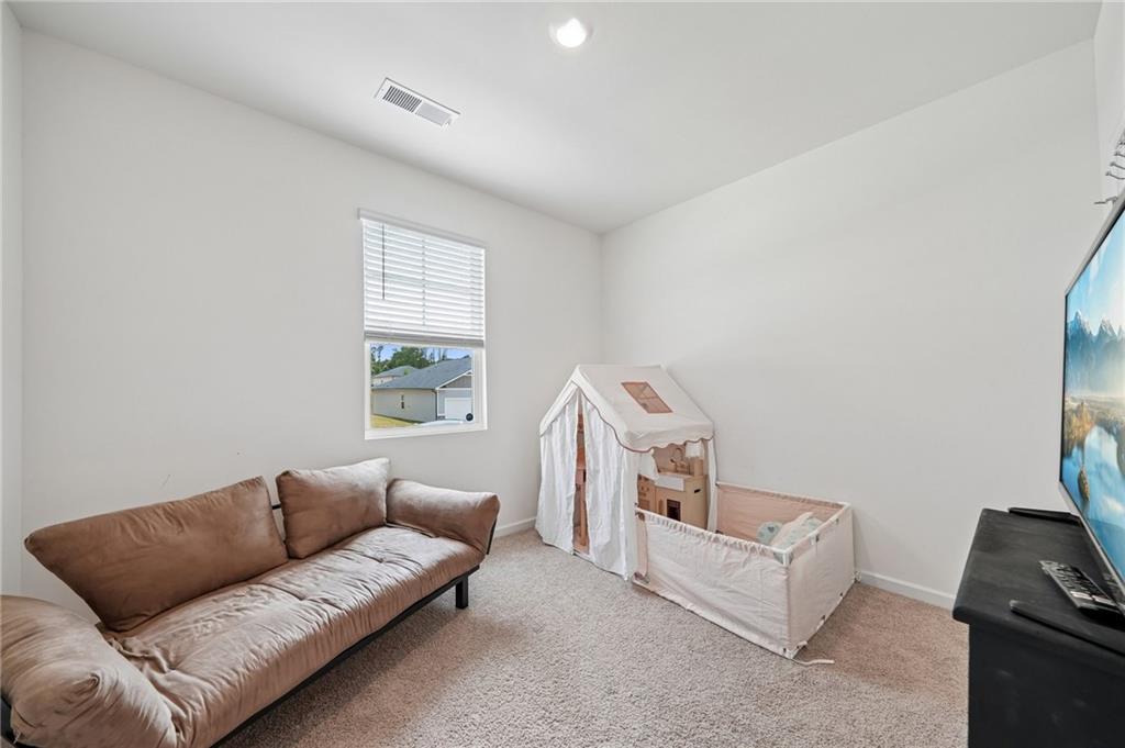 8592 Seabiscuit Road Lithonia, GA 30058 - Photo 16 of 25 a living room with furniture and a window