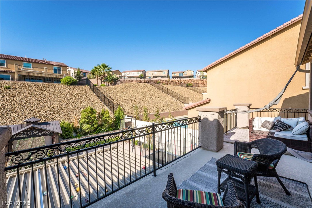 2787 Athens Ridge Drive Henderson, NV 89052 - Photo 26 of 31 Relax on this private balcony offering tranquil views of the terraced landscaping and surrounding community.