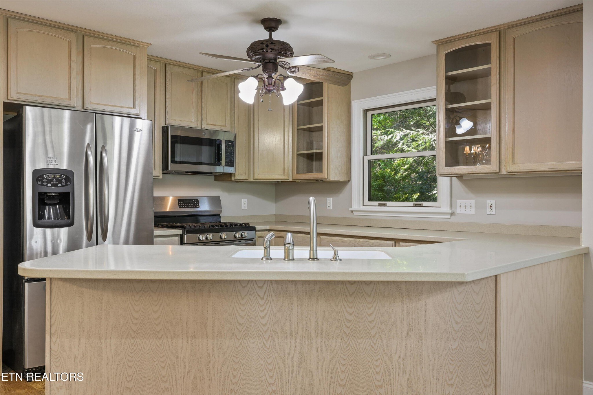 865 Stonegate Way Townsend, TN 37882 - Photo 24 of 60 a kitchen with stainless steel appliances granite countertop a sink a stove and a refrigerator