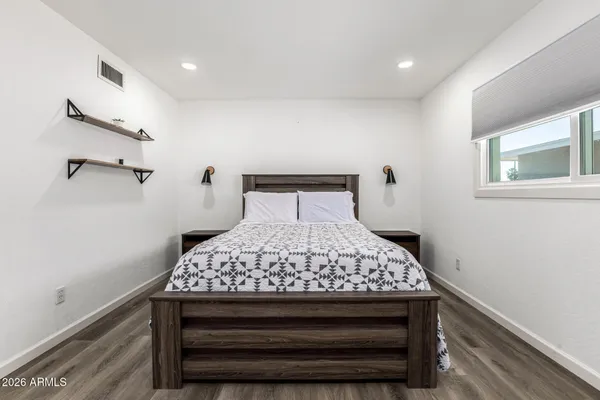 a bedroom with a bed and a window