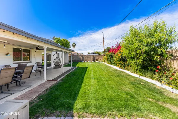 a view of a house with backyard porch and sitting area