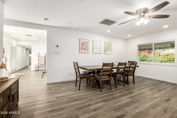 a view of a dining room with furniture and wooden floor
