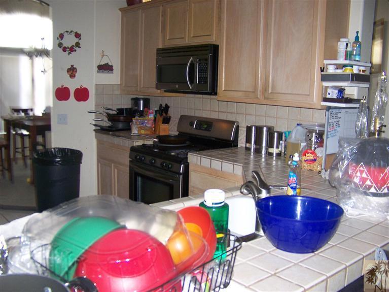 68220 Santelmo Road Cathedral City, CA 92234 - Photo 11 of 21 a kitchen with stainless steel appliances kitchen island granite countertop a sink and a microwave