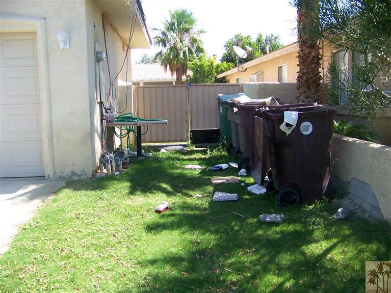 68220 Santelmo Road Cathedral City, CA 92234 - Photo 15 of 21 a view of a backyard with potted plants and a bench