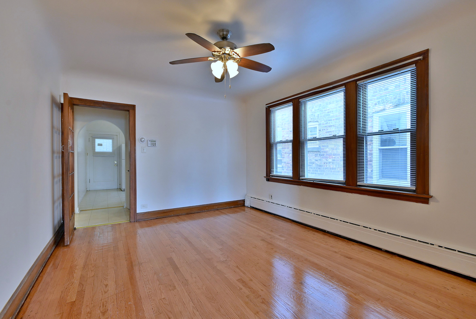 1835 Home Avenue Berwyn, IL 60402 - Photo 11 of 30 a view of an empty room with wooden floor and a window