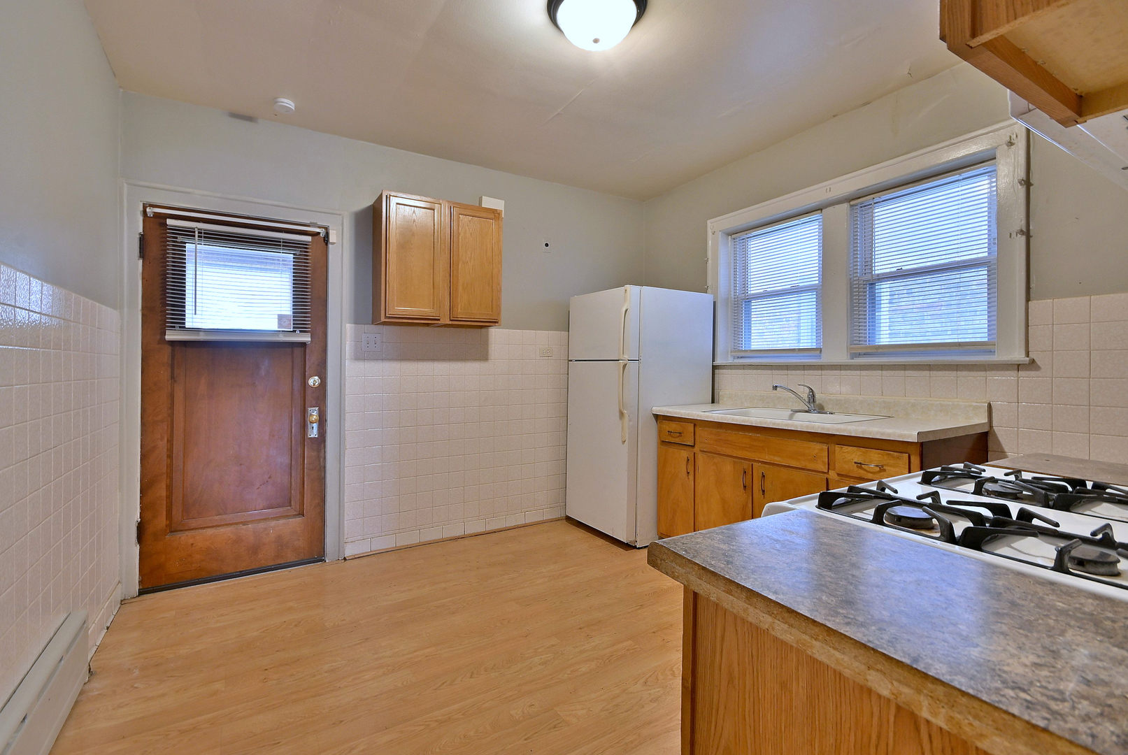 1835 Home Avenue Berwyn, IL 60402 - Photo 23 of 30 a kitchen with a refrigerator and a stove top oven