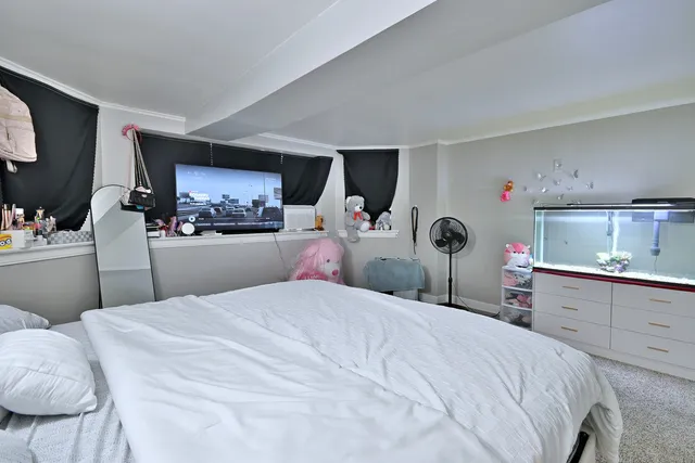 a bedroom with a bed and a television