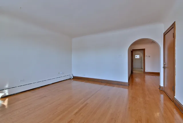 a view of a room with wooden floor and window