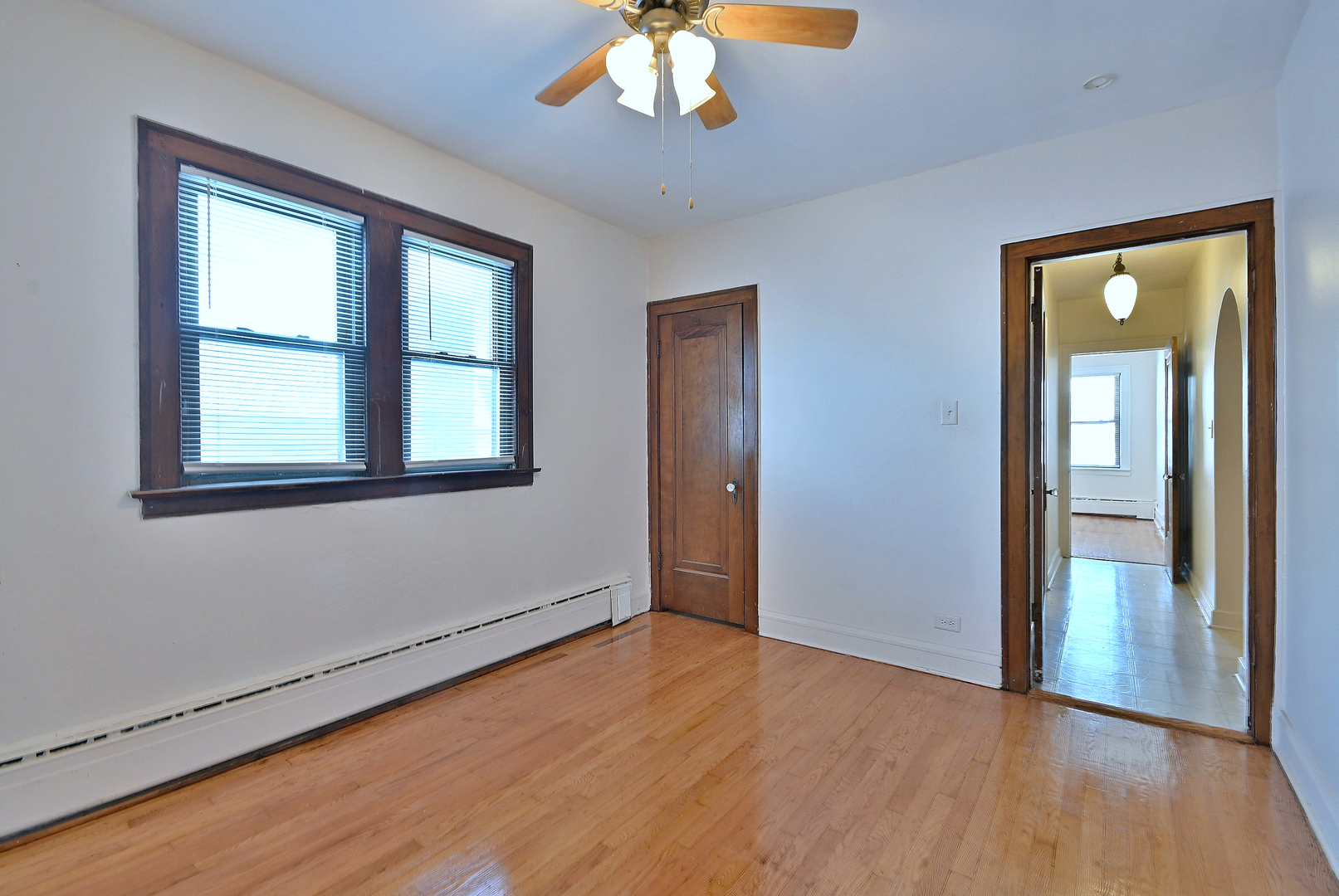 1835 Home Avenue Berwyn, IL 60402 - Photo 6 of 30 an empty room with wooden floor chandelier and windows