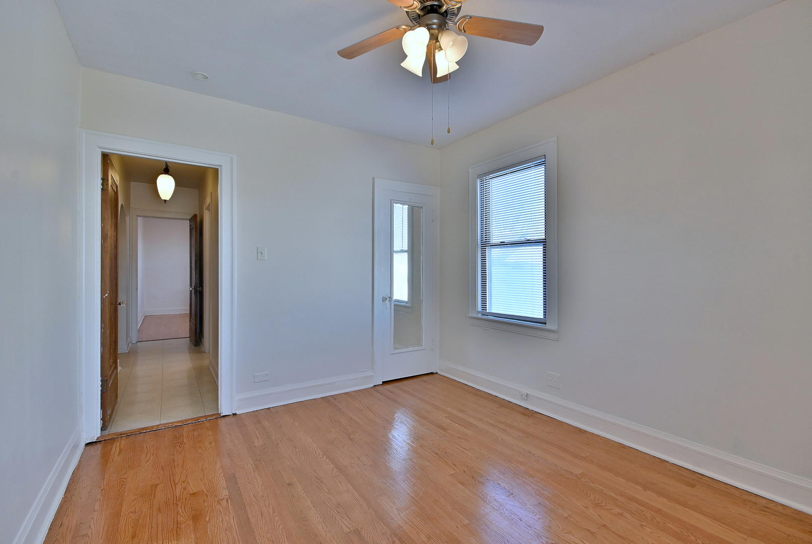 1835 Home Avenue Berwyn, IL 60402 - Photo 8 of 30 a view of an empty room with wooden floor and a window