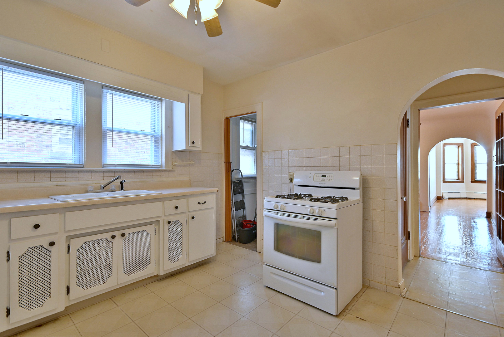 1835 Home Avenue Berwyn, IL 60402 - Photo 10 of 30 a kitchen with white cabinets and white appliances