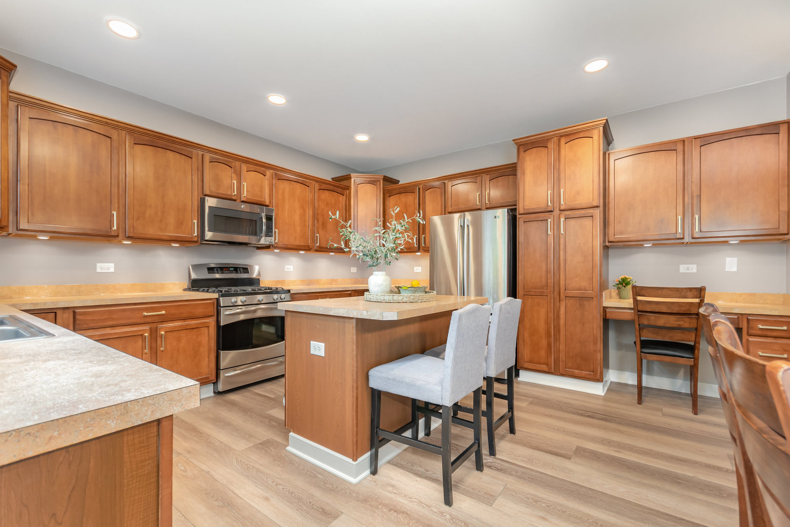 2576 Lyman Loop Yorkville, IL 60560 - Photo 18 of 52 a kitchen with stainless steel appliances granite countertop a stove top oven a sink dishwasher and a refrigerator with wooden floor