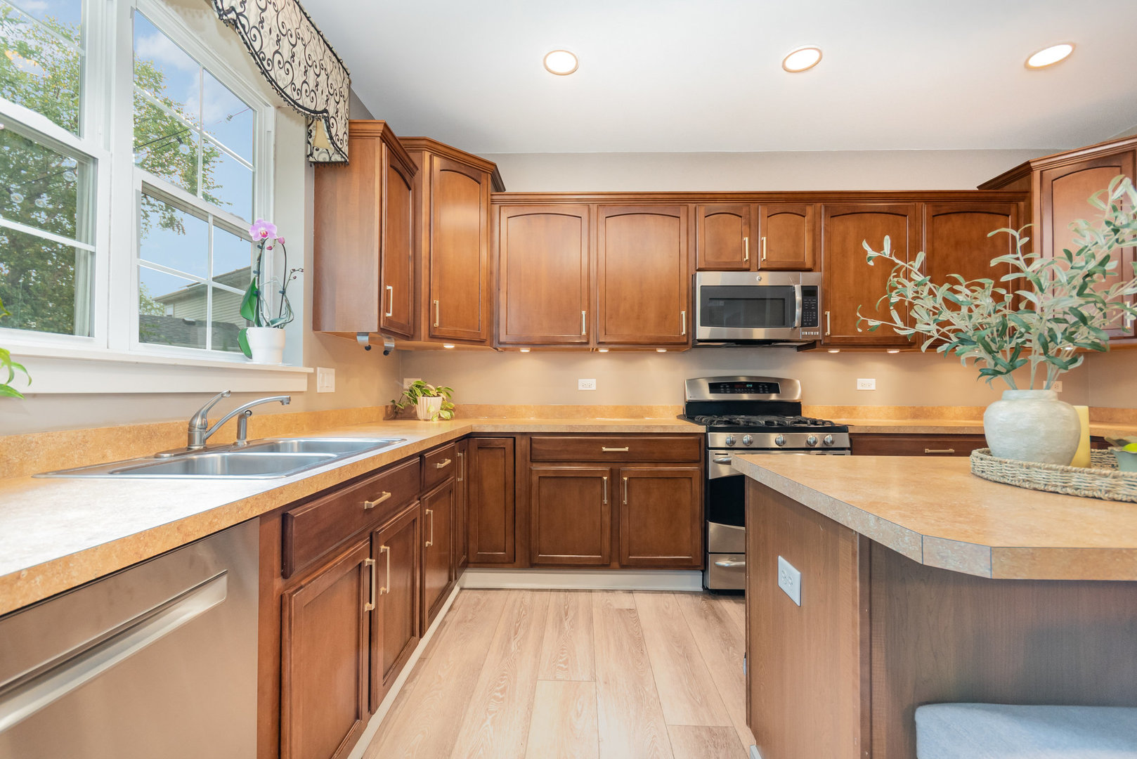 2576 Lyman Loop Yorkville, IL 60560 - Photo 19 of 52 a kitchen with stainless steel appliances granite countertop a sink a stove and a refrigerator
