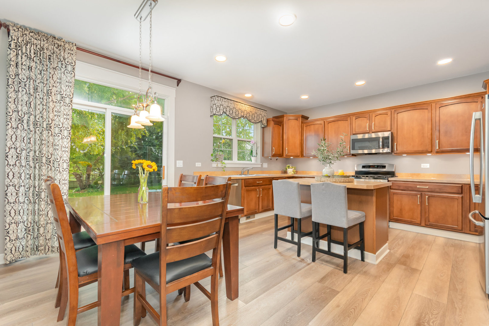 2576 Lyman Loop Yorkville, IL 60560 - Photo 21 of 52 a kitchen with a table chairs sink and cabinets