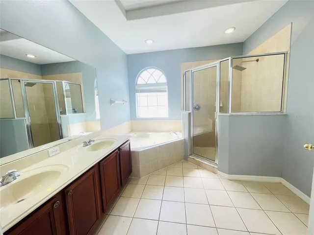 a bathroom with a granite countertop sink mirror and bathtub