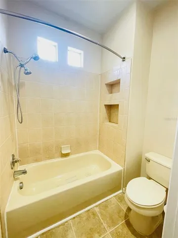a bathroom with a toilet and a bathtub