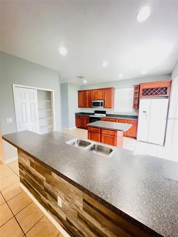 a kitchen with stainless steel appliances granite countertop a sink and a microwave