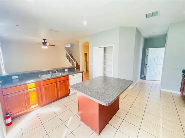 a kitchen with stainless steel appliances granite countertop a sink and a white cabinets
