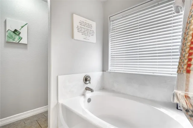 a white bath tub sitting next to a window