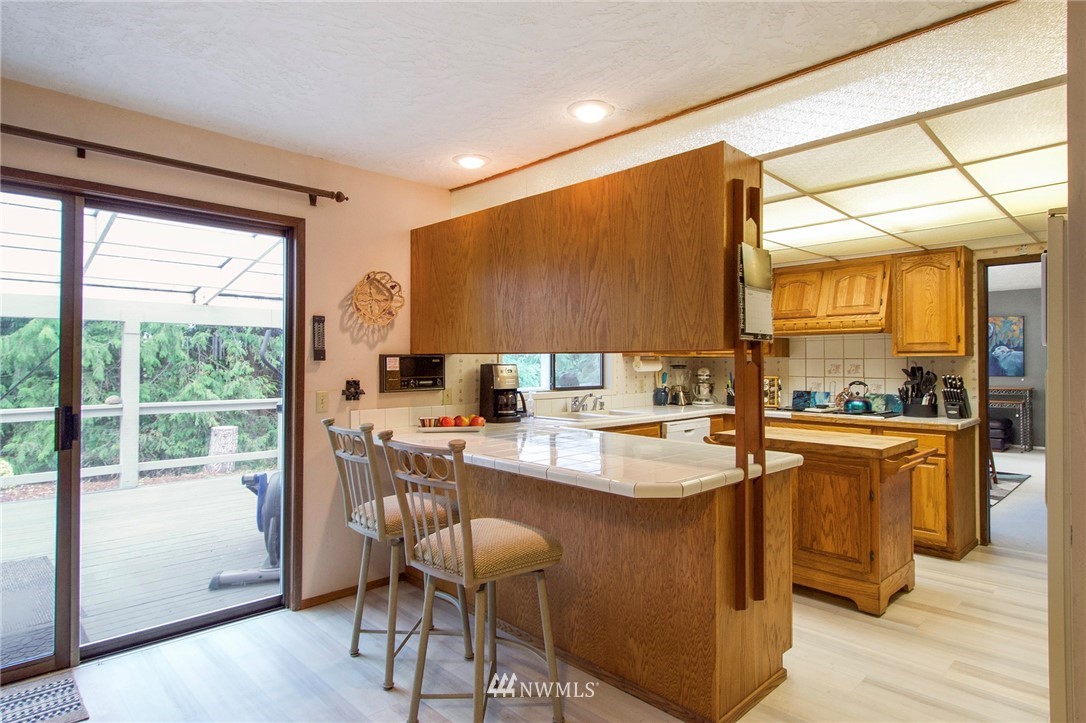 1493 Atterberry Road Sequim, WA 98382 - Photo 12 of 40 a kitchen with a sink a counter top space and stainless steel appliances