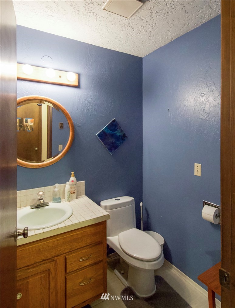 1493 Atterberry Road Sequim, WA 98382 - Photo 17 of 40 a bathroom with a toilet sink and mirror