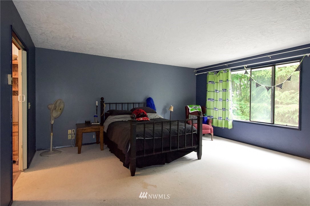 1493 Atterberry Road Sequim, WA 98382 - Photo 18 of 40 a bedroom with a bed and a large window