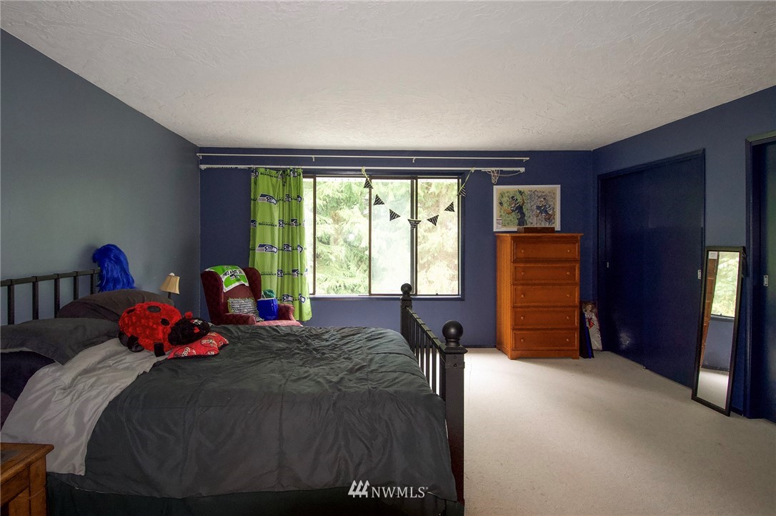 1493 Atterberry Road Sequim, WA 98382 - Photo 19 of 40 a bed room with a bed and a chair